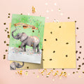 Load image into Gallery viewer, The inside of Tree-Free’s Confetti Elephant card, with the cover and envelope in the background.