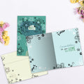 Load image into Gallery viewer, The inside of Tree-Free’s Home Sweet Home card, with the cover and envelope in the background.