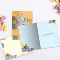 Load image into Gallery viewer, The inside of Tree-Free’s No Place Like Home card, with the cover and envelope in the background.