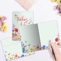 Load image into Gallery viewer, The inside of Tree-Free’s Rainbow Florals card, with the cover and envelope in the background.