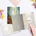 Load image into Gallery viewer, The inside of Tree-Free’s Part Of Us card, with the cover and envelope in the background.