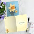 Load image into Gallery viewer, The inside of Tree-Free’s Spring Daffodil card, with the cover and envelope in the background.