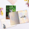 Load image into Gallery viewer, The inside of Tree-Free’s Gray Bunny card, with the cover and envelope in the background.