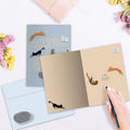 Load image into Gallery viewer, The inside of Tree-Free’s Cats Know card, with the cover and envelope in the background.