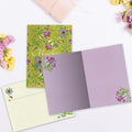 Load image into Gallery viewer, The inside of Tree-Free’s Gracias Flowers card, with the cover and envelope in the background.