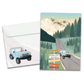 Load image into Gallery viewer, Cover of Year of Adventures Birthday card (featuring script text next to artwork of a car driving down a mountain road) and its matching envelope