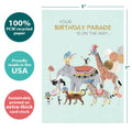 Load image into Gallery viewer, The cover of Tree-Free’s Parade on the Way card with lines demonstrating its 5x7 dimensions, along with the following text: “100% PCW recycled paper, proudly made in the USA, sustainably printed on extra-thick card stock”