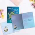 Load image into Gallery viewer, The inside of Tree-Free’s Be Brave card, with the cover and envelope in the background.