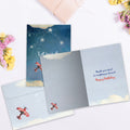 Load image into Gallery viewer, The inside of Tree-Free’s Dreams Take Flight card, with the cover and envelope in the background.