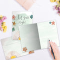 Load image into Gallery viewer, The inside of Tree-Free’s Let Your Light Shine card, with the cover and envelope in the background.