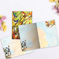 Load image into Gallery viewer, The inside of Tree-Free’s 16 Birds card, with the cover and envelope in the background.