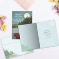 Load image into Gallery viewer, The inside of Tree-Free’s Serene Canoe card, with the cover and envelope in the background.