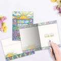 Load image into Gallery viewer, The inside of Tree-Free’s Brand New Day card, with the cover and envelope in the background.