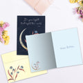 Load image into Gallery viewer, The inside of Tree-Free’s Lights the World card, with the cover and envelope in the background.