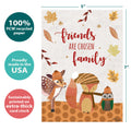 Load image into Gallery viewer, The cover of Tree-Free’s Friends Are Family card with lines demonstrating its 5x7 dimensions, along with the following text: “100% PCW recycled paper, proudly made in the USA, sustainably printed on extra-thick card stock”