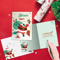 Load image into Gallery viewer, The inside of Tree-Free’s Believe in Magic card, with the cover and envelope in the background.