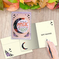 Load image into Gallery viewer, The inside of Tree-Free’s Night Magic card, with the cover and envelope in the background.