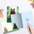 Load image into Gallery viewer, The inside of Tree-Free’s Peaceful Bear card, with the cover and envelope in the background.
