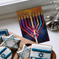 Load image into Gallery viewer, The inside of Tree-Free’s Menorah Glow card, with the cover and envelope in the background.