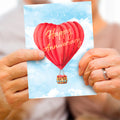 Load image into Gallery viewer, Lifestyle image(s) featuring Tree-Free’s Heart Air Balloon card