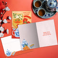 Load image into Gallery viewer, The inside of Tree-Free’s Lucky Tea Set card, with the cover and envelope in the background.