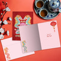 Load image into Gallery viewer, The inside of Tree-Free’s Dragon Lantern card, with the cover and envelope in the background.