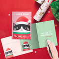 Load image into Gallery viewer, The inside of Tree-Free’s Santa Paws card, with the cover and envelope in the background.