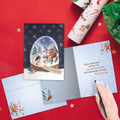 Load image into Gallery viewer, The inside of Tree-Free’s Sweet Snowglobe card, with the cover and envelope in the background.