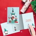 Load image into Gallery viewer, The inside of Tree-Free’s Gnomes Piled High card, with the cover and envelope in the background.