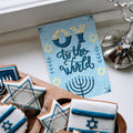 Load image into Gallery viewer, The inside of Tree-Free’s Oy to the World card, with the cover and envelope in the background.