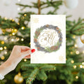 Load image into Gallery viewer, Lifestyle image(s) featuring Tree-Free's Winter Pine Wreath card