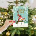 Load image into Gallery viewer, Lifestyle image(s) featuring Tree-Free's Merry Snowman card