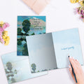 Load image into Gallery viewer, The inside of Tree-Free’s Deep Blue Remembered card, with the cover and envelope in the background.