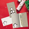 Load image into Gallery viewer, The inside of Tree-Free’s Penguin Pile card, with the cover and envelope in the background.