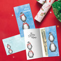 Load image into Gallery viewer, The inside of Tree-Free’s Boho Christmas Penguins card, with the cover and envelope in the background.
