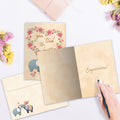 Load image into Gallery viewer, The inside of Tree-Free’s Tied The Knot Elephants card, with the cover and envelope in the background.