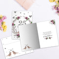 Load image into Gallery viewer, The inside of Tree-Free’s 25 Years of Love card, with the cover and envelope in the background.
