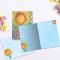 Load image into Gallery viewer, The inside of Tree-Free’s Golden Glow card, with the cover and envelope in the background.
