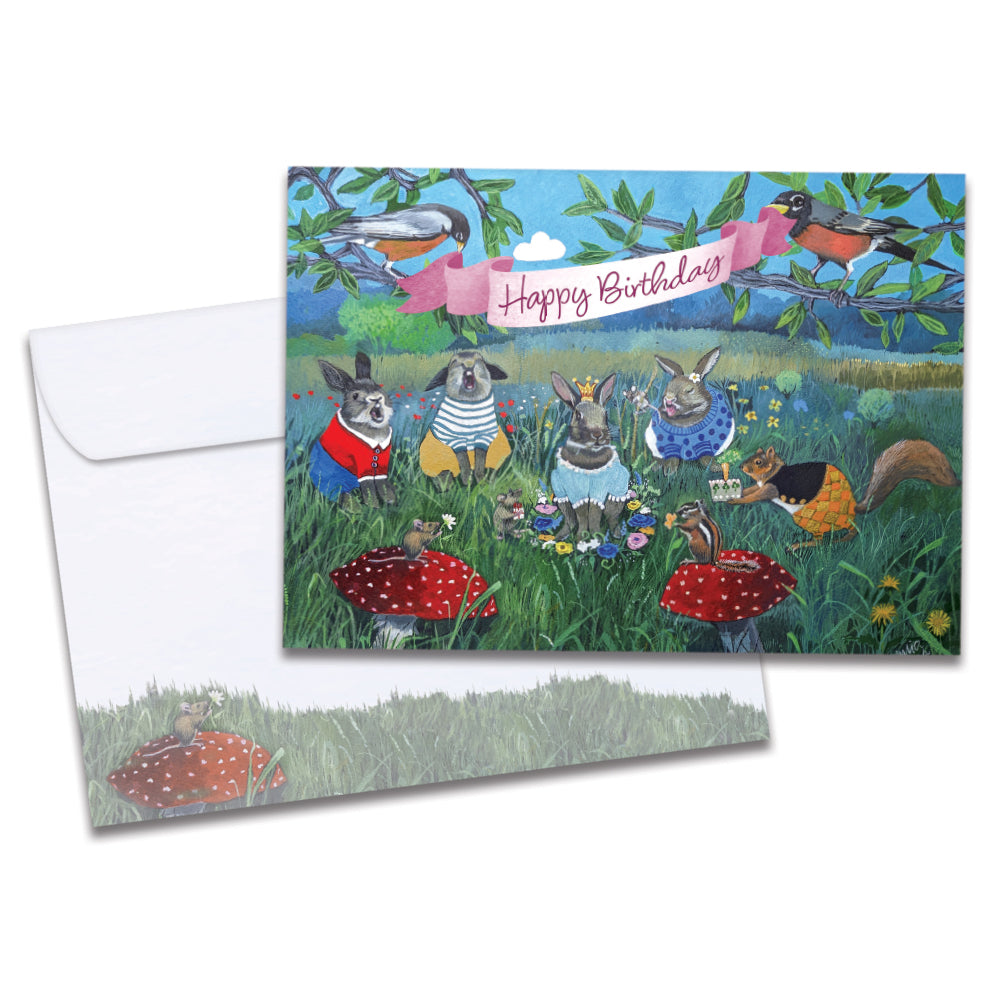 Cover of Bunny Queen Birthday card (featuring script text over artwork of a banner carried by two birds above a group of rabbits and other animals having a party) and its matching envelope