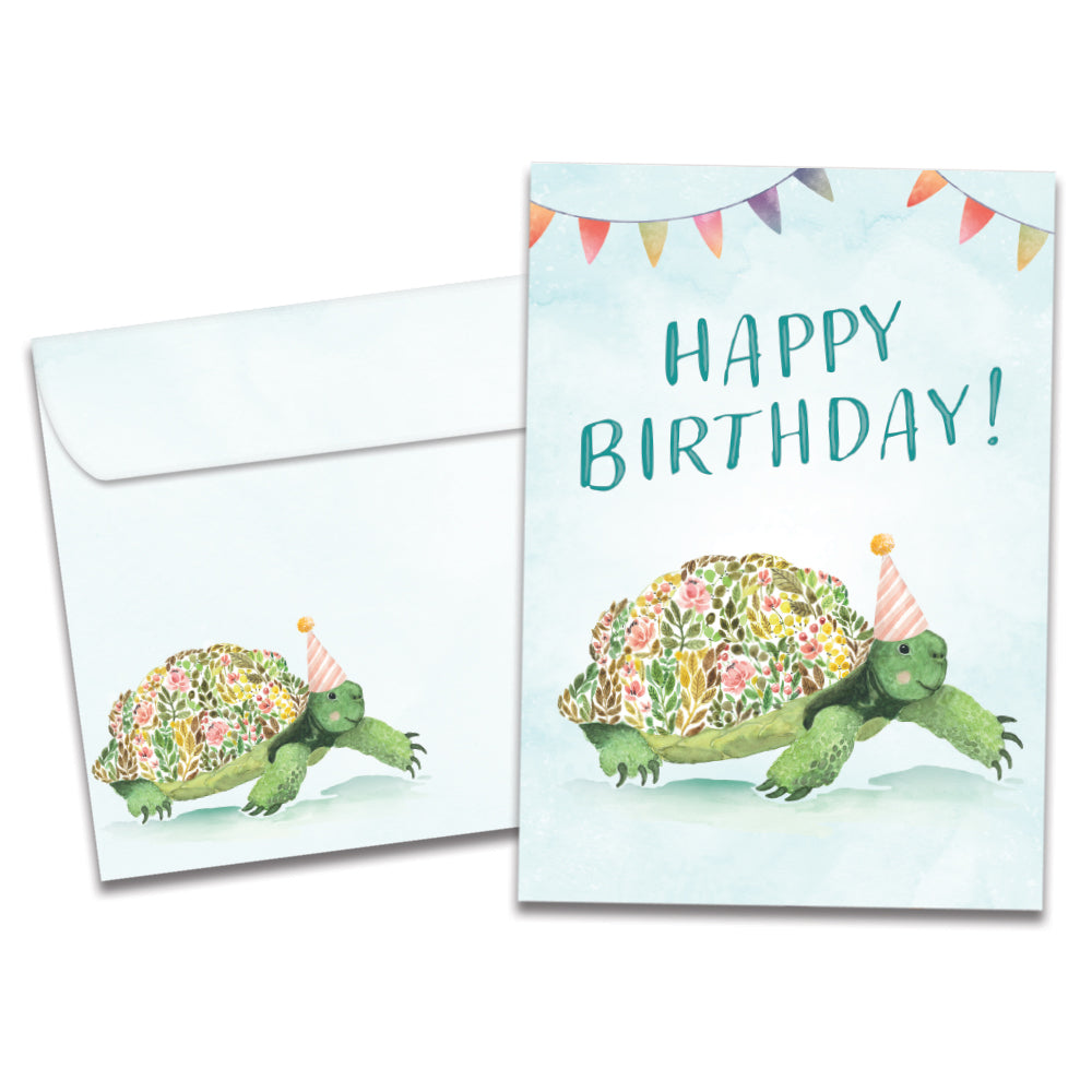Cover of Flower Turtle Birthday card (featuring serif text above artwork of a turtle with a floral print shell wearing a party hat) and its matching envelope