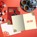 Load image into Gallery viewer, The inside of Tree-Free’s Golden Snake card, with the cover and envelope in the background.
