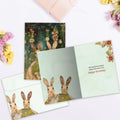 Load image into Gallery viewer, The inside of Tree-Free’s Earth Rabbits card, with the cover and envelope in the background.
