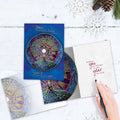 Load image into Gallery viewer, The inside of Tree-Free’s Winter Solstice Mandala card, with the cover and envelope in the background.
