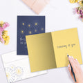 Load image into Gallery viewer, The inside of Tree-Free’s Brighter Stars Support Card card, with the cover and envelope in the background.
