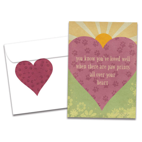 The cover of Tree-Free's Loved Well Pawprints card, along with its matching envelope.