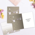 Load image into Gallery viewer, The inside of Tree-Free’s Welcome to the World card, with the cover and envelope in the background.
