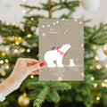 Load image into Gallery viewer, Lifestyle image(s) featuring Tree-Free&#39;s Sweet Polar Christmas Christmas Card card
