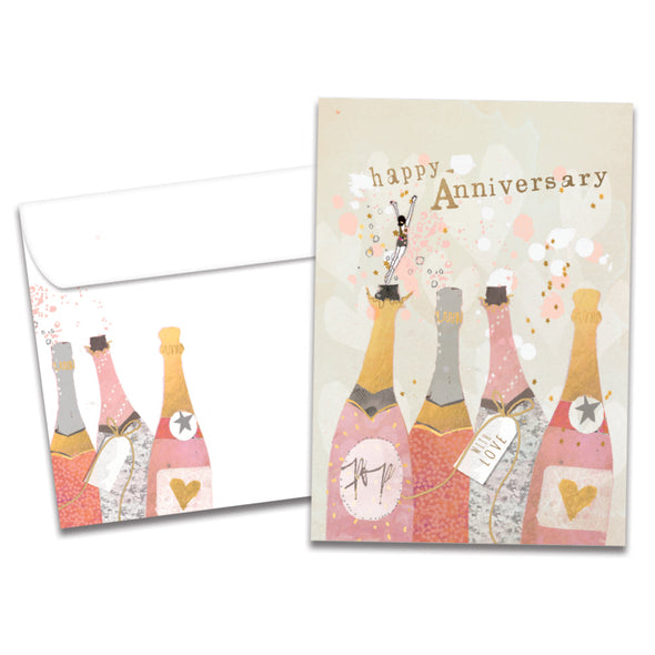 Cover of Champagne Wishes Anniversary card (featuring serif text above artwork of a woman dancing on four bottles of champagne) and its matching envelope