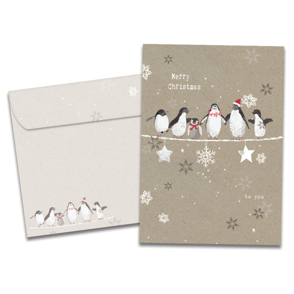 The cover of Tree-Free's Balancing Penguins Christmas Card card, along with its matching envelope.