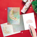 Load image into Gallery viewer, The inside of Tree-Free’s Christmas Dreams Christmas Card card, with the cover and envelope in the background.
